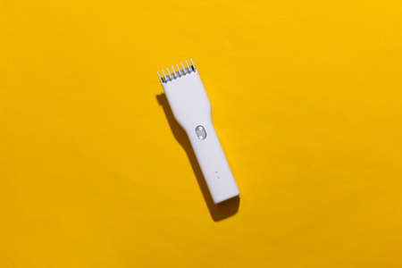 Wireless hair clipper on yellow bright background. top viewの写真素材