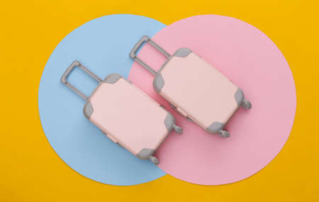 Two Toy travel luggage on colored background. top view. flat lay. minimalismの写真素材