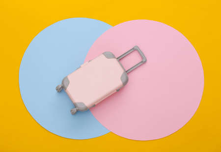 Toy travel luggage on colored background. top view. flat lay. minimalismの写真素材