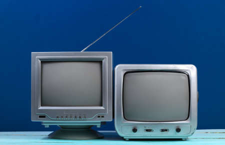 Two Old tv receiver on classic blue background. retro mediaの写真素材