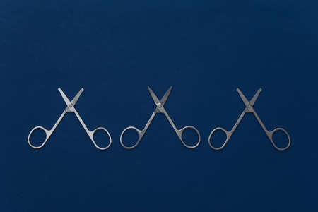 beauty minimalism. Manicure scissors on classic blue background. nail care. top viewの写真素材