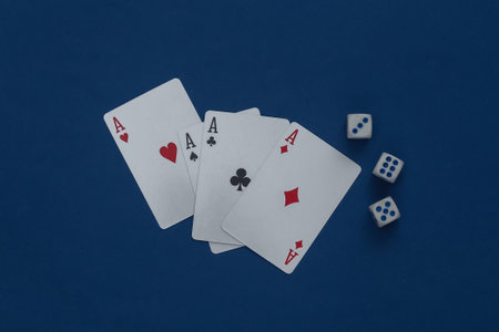 Four aces and dice on a classic blue background.の写真素材