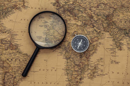 Compass and magnifying glass on old map. Travel, adventure conceptの写真素材