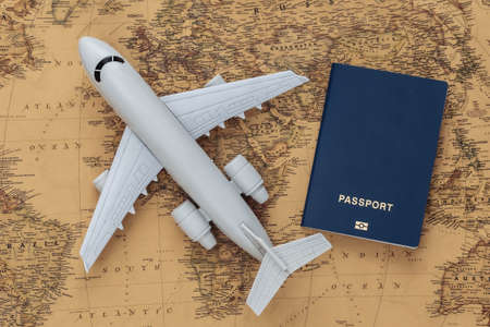 Air plane and passport on old map. Travel, adventure conceptの写真素材