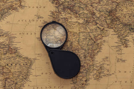 Magnifying glass on old map. Travel, adventure conceptの写真素材