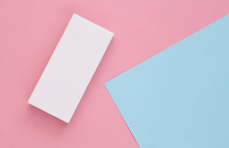 White packing box on pink-blue pastel background. minimalism. top view. copy space