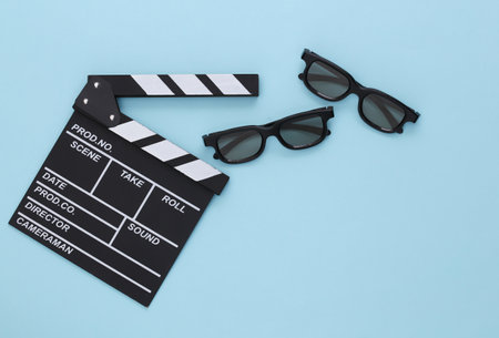 Movie clapper and 3D glasses on blue background. entertainment industry. Cinema. top view