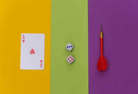Ace of hearts, darts and dice on colored background. top viewの写真素材