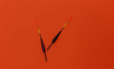 Two fishing floats on orange background. top viewの写真素材