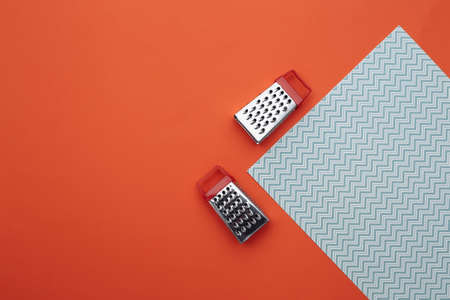 Mini graters on orange blue background. top viewの写真素材