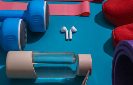 Accessories for sports or fitness on a bright blue background. Athlete's set. Healthy lifestyle...