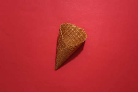 Ice cream waffle cone on red bright background