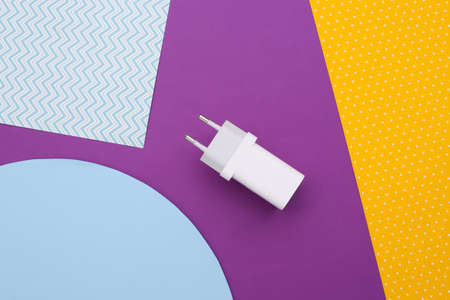 Charger adapter on colored background. top view. Minimalist flat layの写真素材