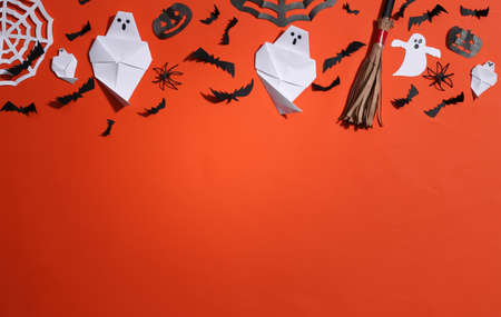 Handmade Halloween paper decor on orange background. Halloween background. copy spaceの写真素材