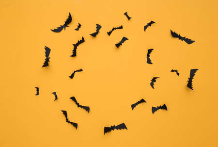 Flying bats on yellow background. Halloween background. top view. flat layの写真素材