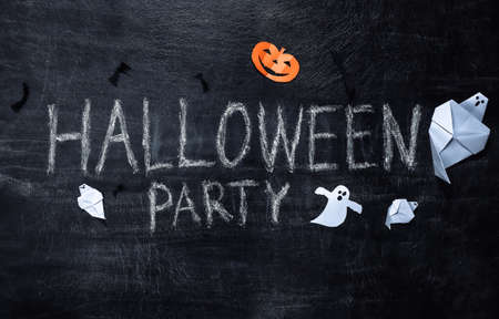 Chalk lettering Halloween party on a chalk board with handmade Halloween decorの写真素材