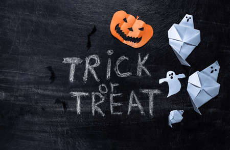 Chalk lettering Trick or Treat on a chalk board. Halloween theme