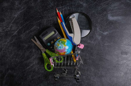 preschool shopping. Supermarket trolley with school supplies on a chalk board. top viewの写真素材