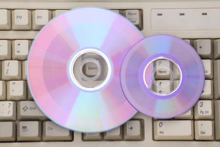 Compact discs on old pc keyboard. top viewの写真素材