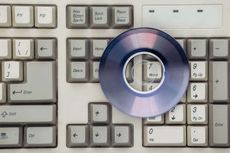 Retro electronics, pc technology 90s. PC keyboard and cd. top viewの写真素材