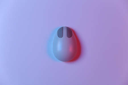 Old pc mouse in pink blue gradient neon light. top view. flat layの写真素材