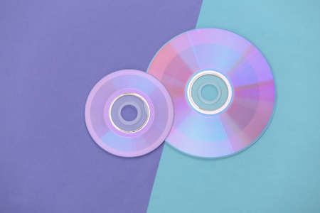 Compact diss on purple blue pastel background. top viewの写真素材