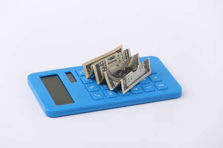 Calculator with hundred dollar bill on a white backgroundの写真素材