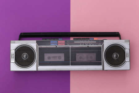 80s Retro Outdated Portable Stereo Radio Cassette Recorder on Pink Purple Background. top viewの写真素材
