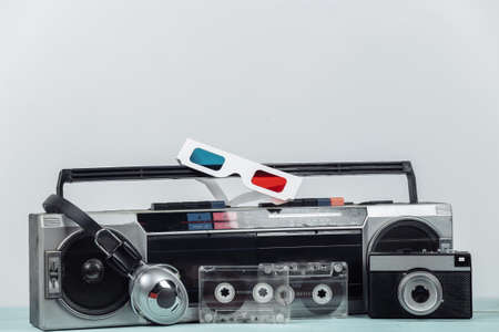 80s Retro outdated portable stereo radio cassette recorder, headphones, audio cassette, 3d glasses, camera on white background. Attributes 80s, retro media, entertainmentの写真素材