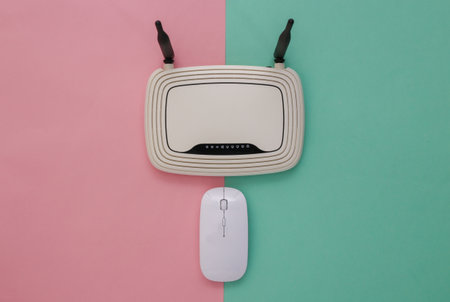 Modern Pc mouse with wifi router on pink blue pastel background. studio shot. top view. flat layの写真素材