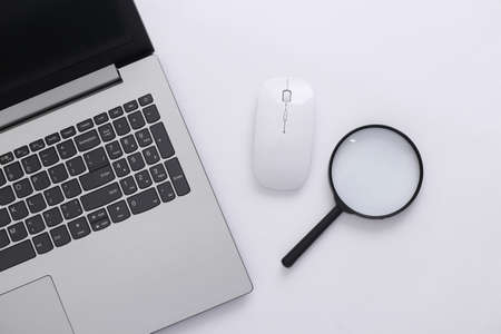 search information. Laptop with pc mouse, magnifier on a white background. top viewの写真素材