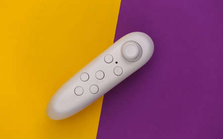 Modern joystick on purple yellow background. top view. Gadgets and devices. flat layの写真素材