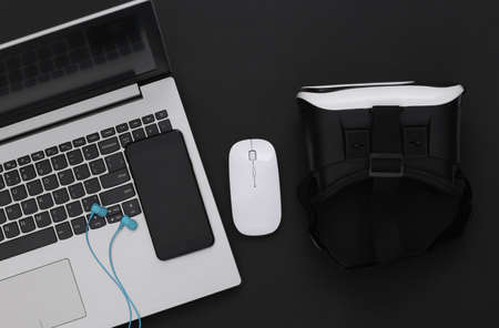 Modern youth gadgets and devices on a black background. top view. flat lay