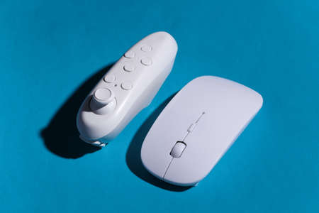 Pc mouse and joustick on blue background with shadow.の写真素材