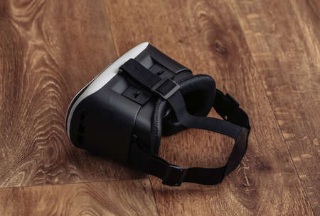 Virtual reality headset with joystick on wooden background. Modern gadgetsの写真素材