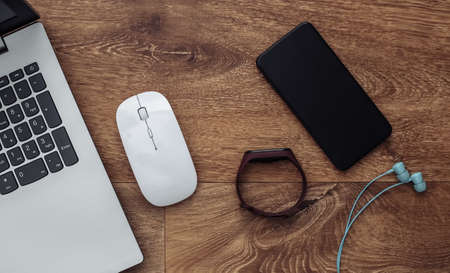 Modern youth gadgets and devices on wooden background. top view. flat layの写真素材