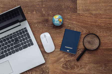 Flat lay composition of laptop and travel accessories on a wooden floor. tourism. top view.の写真素材