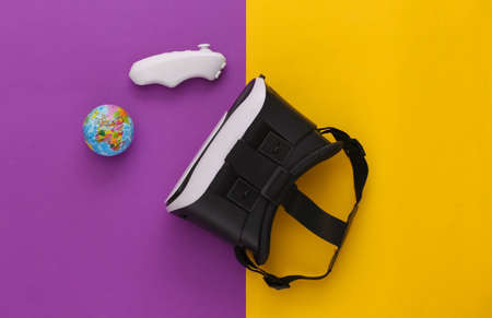 Virtual travel. Virtual reality headset with globe, joystick on yellow purple background. top view