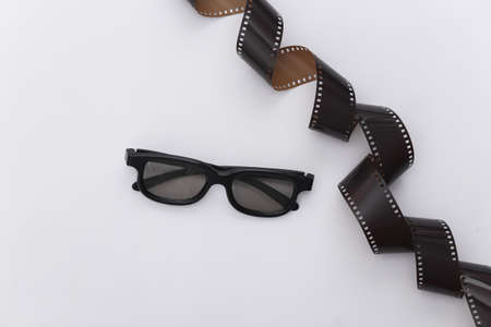 Film tape and 3d glasses on white background. Cinema, Entertainment industry. top viewの写真素材