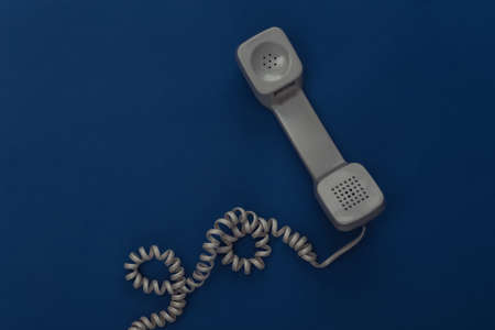 Retro wired handset on classic blue background. Color 2020. Top view.の写真素材