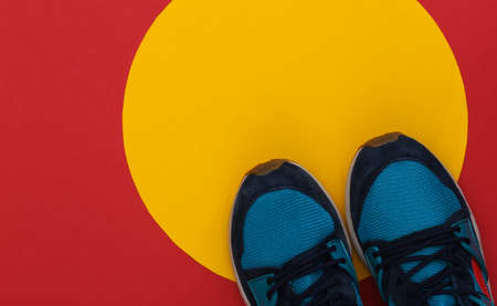 Running shoes (sneakers) on red yellow background. healthy lifestyle. top viewの写真素材