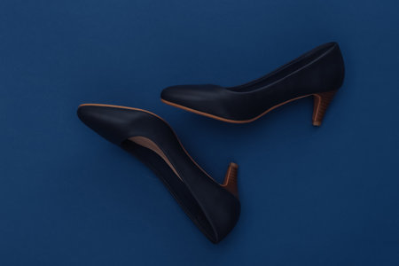 Fashionable leather high heel shoes on a classic blue background. Color 2020. Top view.の写真素材