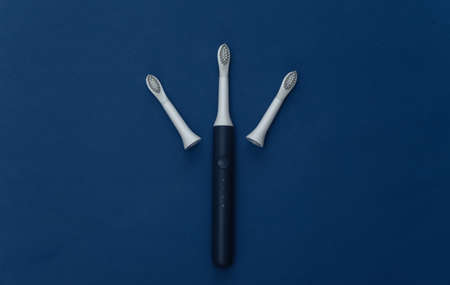 Electro toothbrush with replaceable heads on classic blue background. Color 2020の写真素材