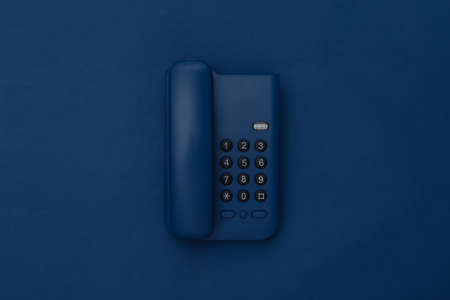 Landline phone on classic blue background. Color 2020の写真素材