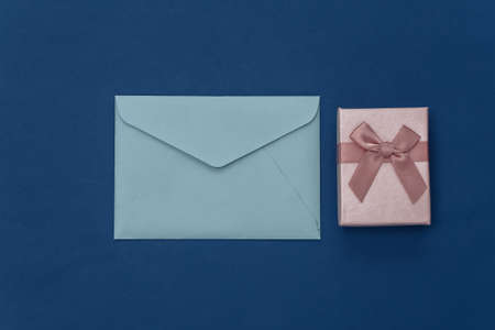 Gift box and envelope on classic blue background. Color 2020の写真素材