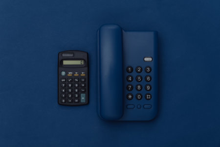 Landline phone with calculator on classic blue background. Color 2020の写真素材