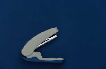 Stapler on classic blue background. Color 2020の写真素材