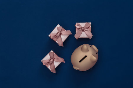 Piggy bank with gift boxes on classic blue background. Color 2020. Top view.の写真素材