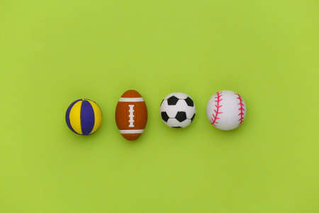 Mini balls of different sports on green background. Minimalism Sport concept. top view. flat lay.の写真素材