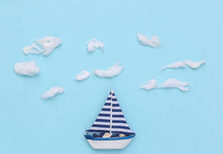 Sailboat on hand made sky background with clouds